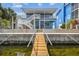 Stilt home with wooden dock, enhancing waterfront appeal with access to coastal waterways at 4039 Casa Ct, Hernando Beach, FL 34607
