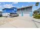 Charming two-story home with a two-car garage and a boat on a trailer in the driveway at 4039 Casa Ct, Hernando Beach, FL 34607