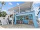 Outdoor covered bar area with seating, string lights, and access to the upper level of a charming waterfront home at 4039 Casa Ct, Hernando Beach, FL 34607