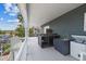 Spacious outdoor kitchen on a covered porch, complete with cabinets, sink, and appliances at 4039 Casa Ct, Hernando Beach, FL 34607