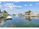 Scenic waterfront view showcasing a canal lined with houses, docks, and boats under a partly cloudy sky at 4039 Casa Ct, Hernando Beach, FL 34607