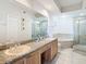 Bright bathroom featuring double sinks, a soaking tub, and a glass-enclosed shower, for a spa-like experience at 4516 Seagull Dr # 903, New Port Richey, FL 34652
