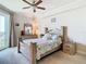 Cozy bedroom featuring a wooden bed frame, ceiling fan, and balcony access, providing a relaxing retreat at 4516 Seagull Dr # 903, New Port Richey, FL 34652