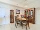 Dining room with classic wooden furniture, carpet flooring, and a decorative chandelier at 4516 Seagull Dr # 903, New Port Richey, FL 34652