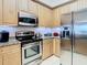 Bright kitchen featuring stainless steel appliances and granite counters at 4516 Seagull Dr # 903, New Port Richey, FL 34652
