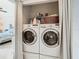 Convenient laundry area equipped with a stacked washer and dryer, optimizing space and functionality at 4516 Seagull Dr # 903, New Port Richey, FL 34652