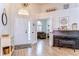 The foyer features wood flooring, a piano and a glimpse into the living room beyond French doors at 5114 Whispering Leaf Trl, Valrico, FL 33596