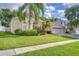 Single-story home featuring a well-manicured lawn and landscaping with a two-car garage at 5114 Whispering Leaf Trl, Valrico, FL 33596