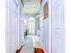 Hallway with wood and tile floors leads to the bathroom; also shown are multiple storage closets at 5114 Whispering Leaf Trl, Valrico, FL 33596