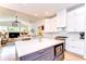 Open kitchen featuring island with a built-in microwave, stylish cabinetry, and open sight lines to Gathering room at 5114 Whispering Leaf Trl, Valrico, FL 33596