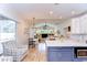 Bright, open-concept kitchen with a spacious island, stainless appliances, and seamless transition to living spaces at 5114 Whispering Leaf Trl, Valrico, FL 33596