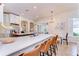 Bright and modern kitchen with a large island, stainless appliances, and seamless transition to dining area at 5114 Whispering Leaf Trl, Valrico, FL 33596