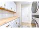 Laundry room with modern washer and dryer and ample cabinet space for storage at 5114 Whispering Leaf Trl, Valrico, FL 33596