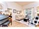 Inviting living room showcases hard surface floors, comfortable seating and access to an outdoor pool area at 5114 Whispering Leaf Trl, Valrico, FL 33596