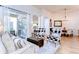 Inviting living room with plush seating, an ottoman, stylish armchairs, and an abundance of natural light at 5114 Whispering Leaf Trl, Valrico, FL 33596