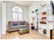 Cozy living room with a large window, built-in shelving and wood-look floors at 5114 Whispering Leaf Trl, Valrico, FL 33596