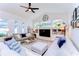 Comfortable living room with plush seating, built-in shelving, and plenty of natural light from large windows at 5114 Whispering Leaf Trl, Valrico, FL 33596