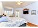The main bedroom features hardwood floors, a tray ceiling, and access to the lanai for indoor/outdoor living at 5114 Whispering Leaf Trl, Valrico, FL 33596