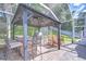 The outdoor kitchen features a grill, bar seating, and dining table at 5114 Whispering Leaf Trl, Valrico, FL 33596