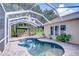A screened-in pool area with a gazebo and outdoor seating, perfect for relaxing at 5114 Whispering Leaf Trl, Valrico, FL 33596