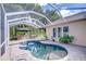 Screened-in pool with gazebo-covered outdoor kitchen and landscaped surroundings at 5114 Whispering Leaf Trl, Valrico, FL 33596