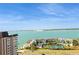 High-angle view of a beautiful coastal complex with a tennis court and water views against a clear sky at 5200 Brittany S Dr # 1807, St Petersburg, FL 33715