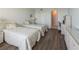 Bedroom featuring two beds, a desk and updated flooring at 5200 Brittany S Dr # 1807, St Petersburg, FL 33715