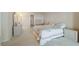 Spacious bedroom featuring neutral carpet and furnishings and light walls and bedding at 5200 Brittany S Dr # 1807, St Petersburg, FL 33715