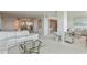 Open-concept living room and dining area with chandeliers and bedroom access at 5200 Brittany S Dr # 1807, St Petersburg, FL 33715