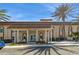 Welcoming Resident's Club exterior featuring red flowers, palm trees, and comfortable seating at 5200 Brittany S Dr # 1807, St Petersburg, FL 33715
