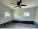 Spacious garage interior showcasing a ceiling fan and natural light through the windows at 5312 Berkley Rd, New Port Richey, FL 34652