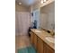 Well-lit bathroom with dual sinks, granite countertops and tiled floors, offering both style and functionality at 584 52Nd N Ave, St Petersburg, FL 33703