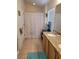 Bathroom featuring dual sinks, granite countertops, and shower with patterned curtain for a refreshed and stylish space at 584 52Nd N Ave, St Petersburg, FL 33703