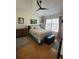 Bright bedroom featuring a comfortable bed, wood floors, and ample natural light from the large window at 584 52Nd N Ave, St Petersburg, FL 33703