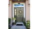 Inviting front door with wreath, sidelight, transom window and decorative plants at 584 52Nd N Ave, St Petersburg, FL 33703