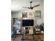 Inviting living room with unique decor, a large TV, ceiling fan and creative shelving for a personalized touch at 584 52Nd N Ave, St Petersburg, FL 33703