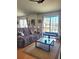 Bright living room featuring hardwood floors, comfortable seating, and sliding glass doors at 584 52Nd N Ave, St Petersburg, FL 33703