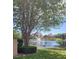 Scenic pond view with a fountain surrounded by lush greenery and neighborhood homes on a sunny day at 584 52Nd N Ave, St Petersburg, FL 33703