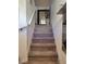 Carpeted staircase with white railing and decorative mirror leading to upper level at 584 52Nd N Ave, St Petersburg, FL 33703