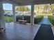 Building entrance featuring tile flooring, a bench, and well-maintained landscaping at 5970 80Th N St # 312, St Petersburg, FL 33709