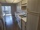 Well-lit kitchen with white appliances and cabinetry plus linoleum flooring at 5970 80Th N St # 312, St Petersburg, FL 33709
