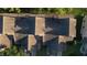 Aerial shot of the home's roof, backyard, and driveway with green trees and foliage at 6516 Remus Dr, New Port Richey, FL 34653
