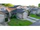 Aerial view of a cozy townhouse in a residential neighborhood with mature trees and well-kept lawns at 6516 Remus Dr, New Port Richey, FL 34653