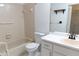 Bathroom featuring a tub, toilet, vanity with sink, and neutral tiling at 6516 Remus Dr, New Port Richey, FL 34653