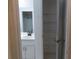 Bathroom vanity with a sink, storage, and a view of an open closet at 6516 Remus Dr, New Port Richey, FL 34653