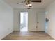 Bedroom with wood-look floors, ceiling fan, and access to bathroom and kitchen at 6516 Remus Dr, New Port Richey, FL 34653