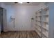 Bedroom with built-in bookshelves and laminate flooring, ready to be personalized at 6516 Remus Dr, New Port Richey, FL 34653