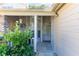Inviting front porch with seating, and tasteful decor, complemented by lush green plants and a bright entry at 6516 Remus Dr, New Port Richey, FL 34653