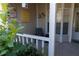 Charming front porch featuring a chair, decorative elements, and green shrubbery enhancing curb appeal at 6516 Remus Dr, New Port Richey, FL 34653