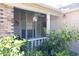 Cozy front porch featuring outdoor seating, decorative elements, and green shrubbery enhancing curb appeal at 6516 Remus Dr, New Port Richey, FL 34653